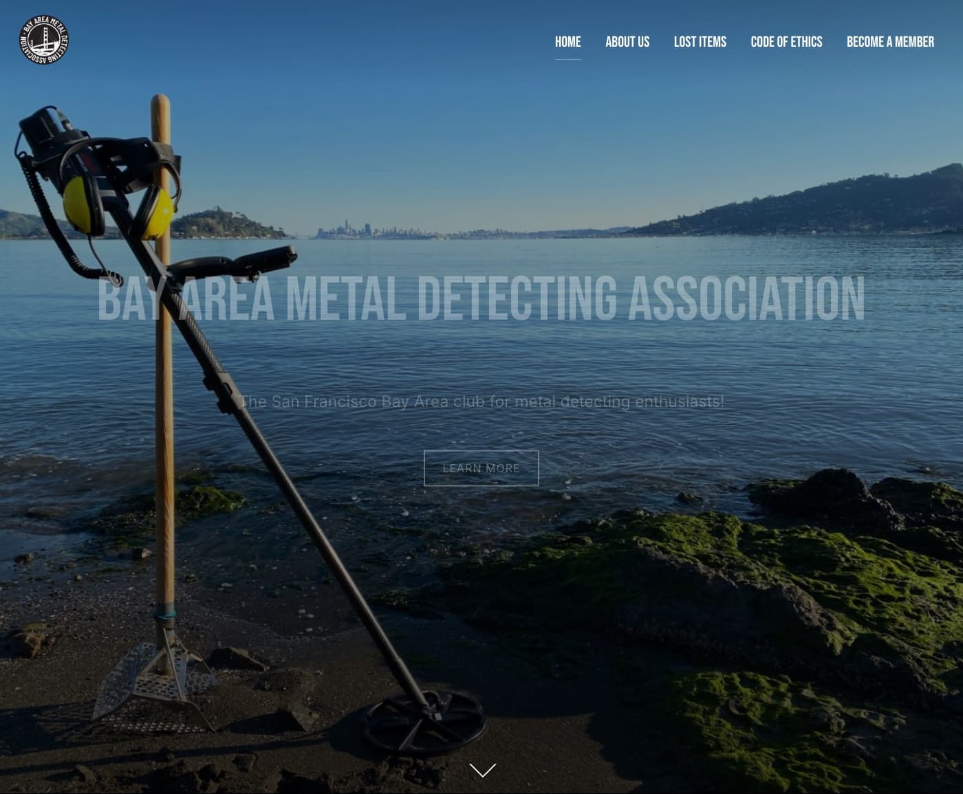 Bay Area Metal Detecting Association homepage, with a detector on a rocky shoreline and the bay behind it.